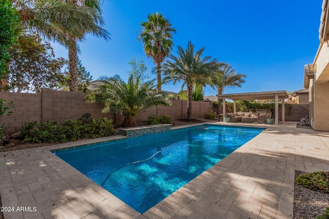 view of swimming pool featuring outdoor lounge area and a patio