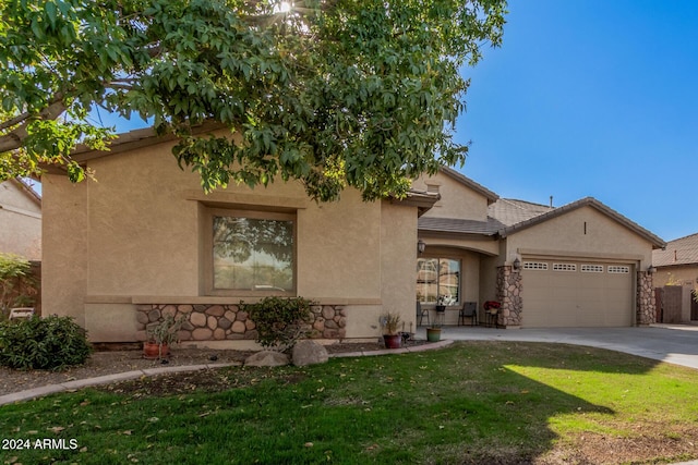 view of front of home featuring a garage and a front lawn