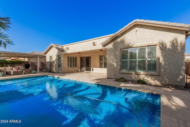 view of pool featuring an outdoor living space and a patio