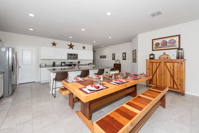 dining space featuring light tile patterned flooring