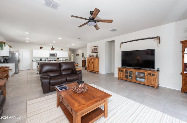 tiled living room with ceiling fan