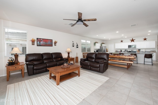 living room with light tile patterned floors and ceiling fan