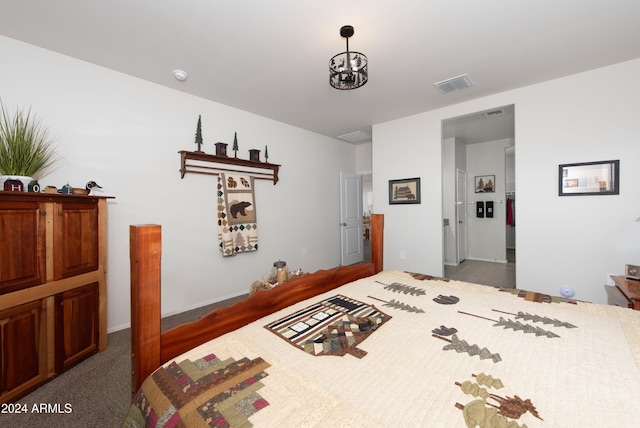 bedroom with dark colored carpet