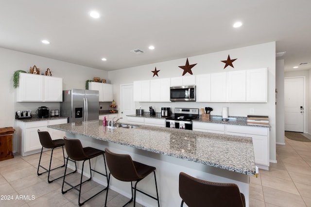 kitchen featuring sink, white cabinetry, a kitchen island with sink, and appliances with stainless steel finishes