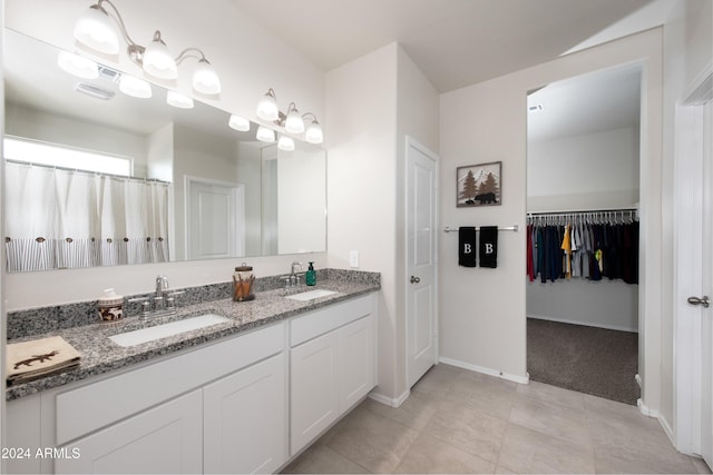 bathroom with tile patterned flooring and vanity