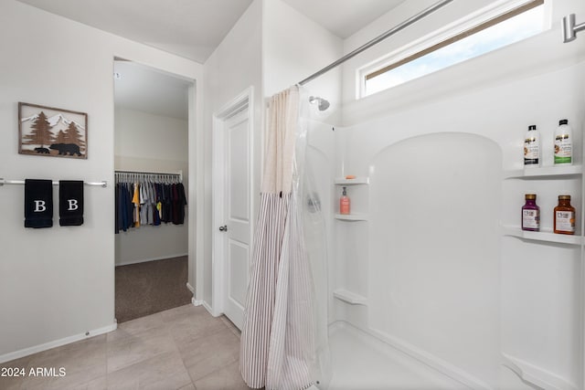 bathroom with tile patterned floors and curtained shower