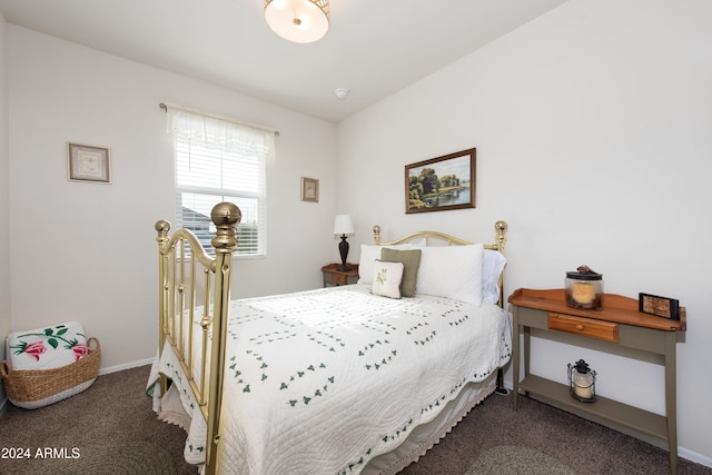 bedroom featuring dark carpet