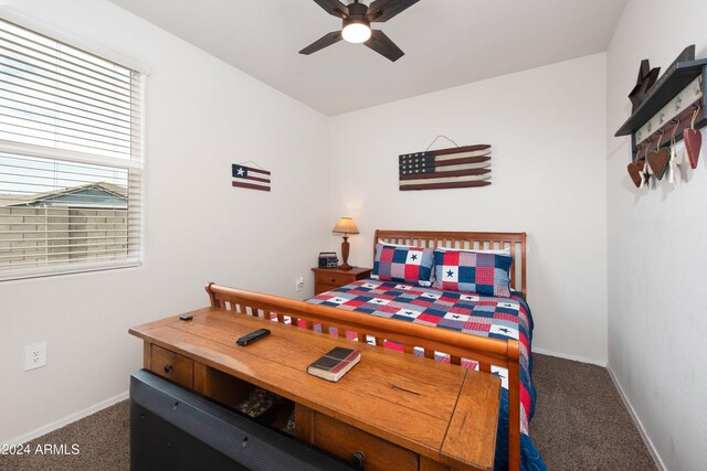 bedroom featuring dark carpet and ceiling fan