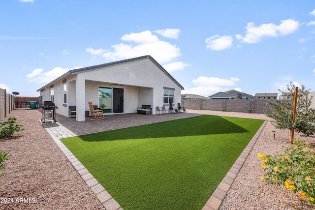 rear view of house featuring a patio area, ceiling fan, and a yard