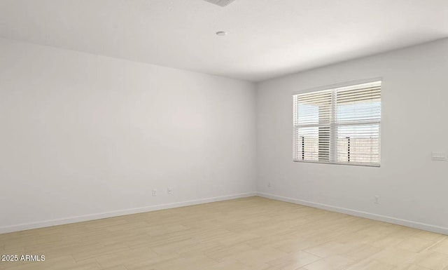 empty room featuring baseboards