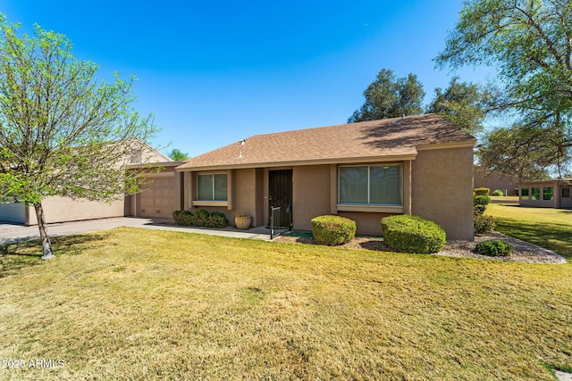 ranch-style home featuring a front yard, driveway, an attached garage, and stucco siding