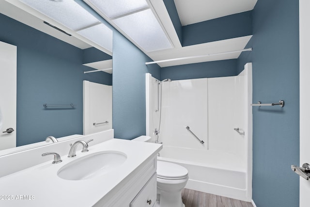 bathroom featuring tub / shower combination, vanity, toilet, and wood finished floors