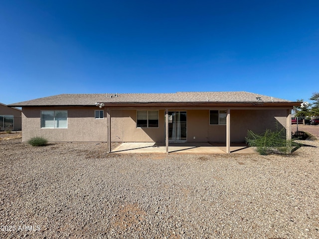 back of house featuring stucco siding and a patio area