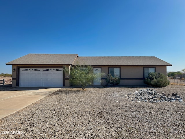 single story home featuring an attached garage, stucco siding, and concrete driveway