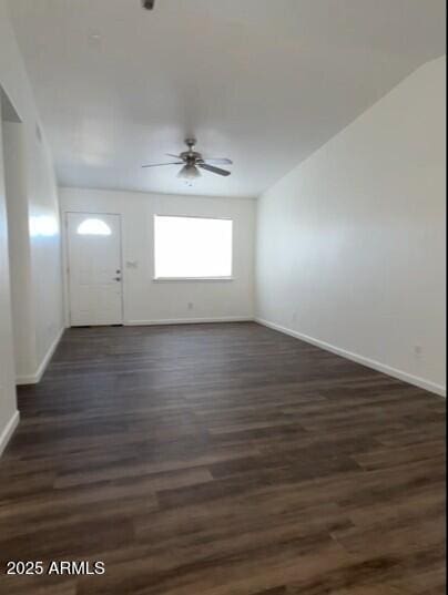 entryway featuring ceiling fan, baseboards, and dark wood-type flooring