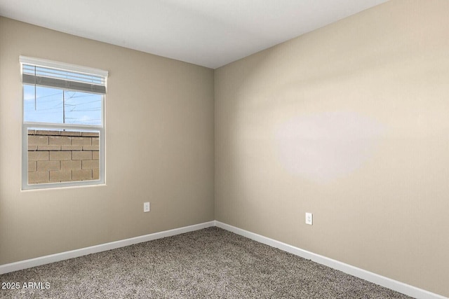 unfurnished room with baseboards and carpet