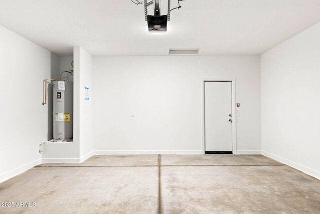 garage featuring baseboards, a garage door opener, and water heater