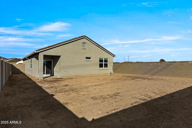 rear view of property with a fenced backyard