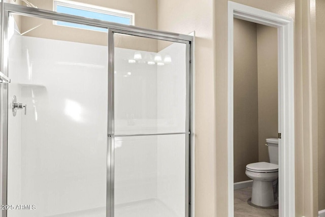 full bath with toilet and a stall shower
