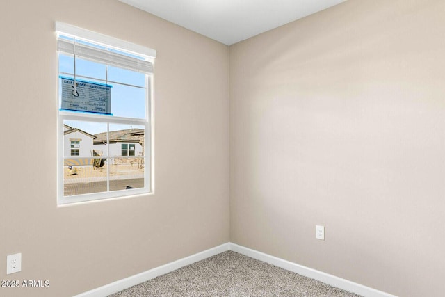 empty room with baseboards and carpet flooring