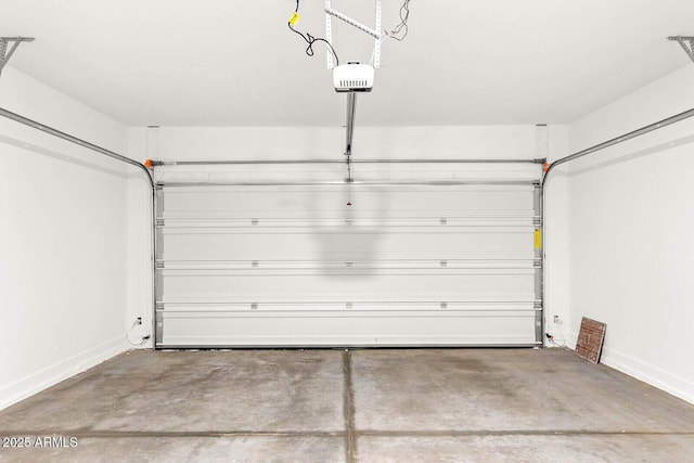garage featuring baseboards and a garage door opener