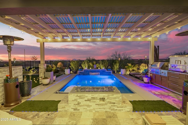 view of pool with exterior kitchen, grilling area, a fenced backyard, and a fenced in pool