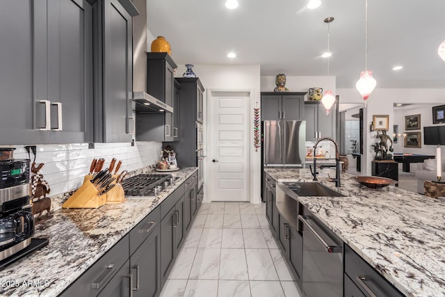 kitchen with marble finish floor, light stone counters, a sink, and stainless steel appliances