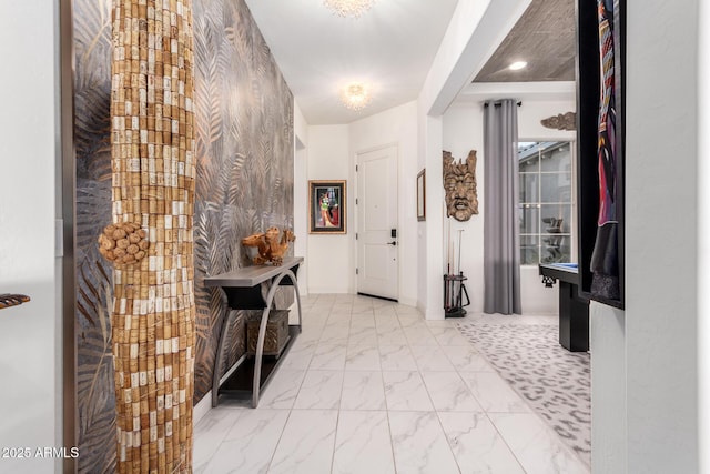 foyer featuring marble finish floor and baseboards