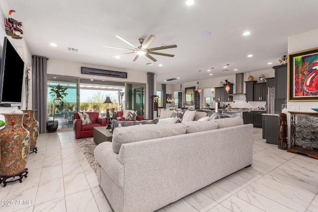 living room featuring ceiling fan, marble finish floor, visible vents, and recessed lighting