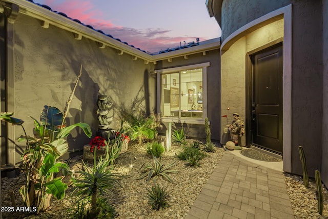 doorway to property with stucco siding