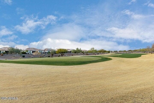 view of community featuring a lawn and golf course view