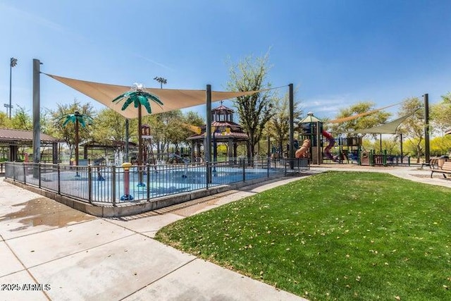 view of sport court with a yard, playground community, and fence