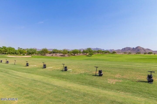 view of community featuring a lawn and a mountain view