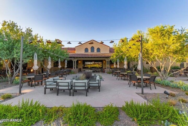 view of community with outdoor dining area and a patio area