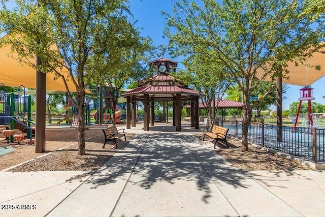 surrounding community with playground community, fence, and a gazebo