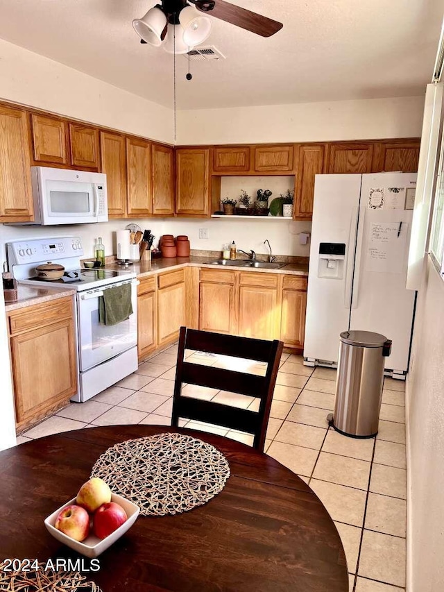 kitchen featuring ceiling fan, sink, light tile patterned flooring, and white appliances