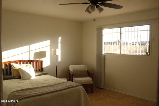 bedroom with ceiling fan and light tile patterned floors