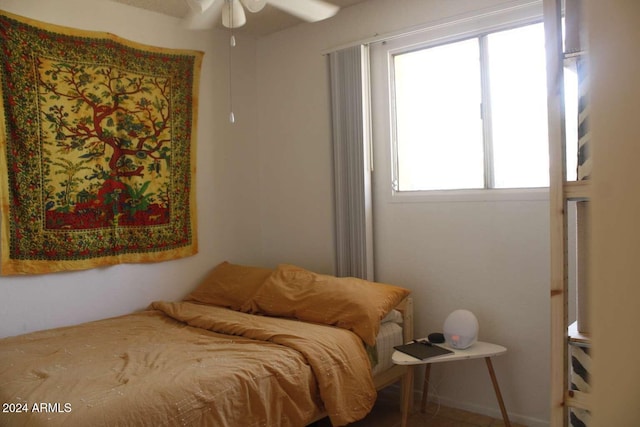 bedroom with multiple windows and ceiling fan