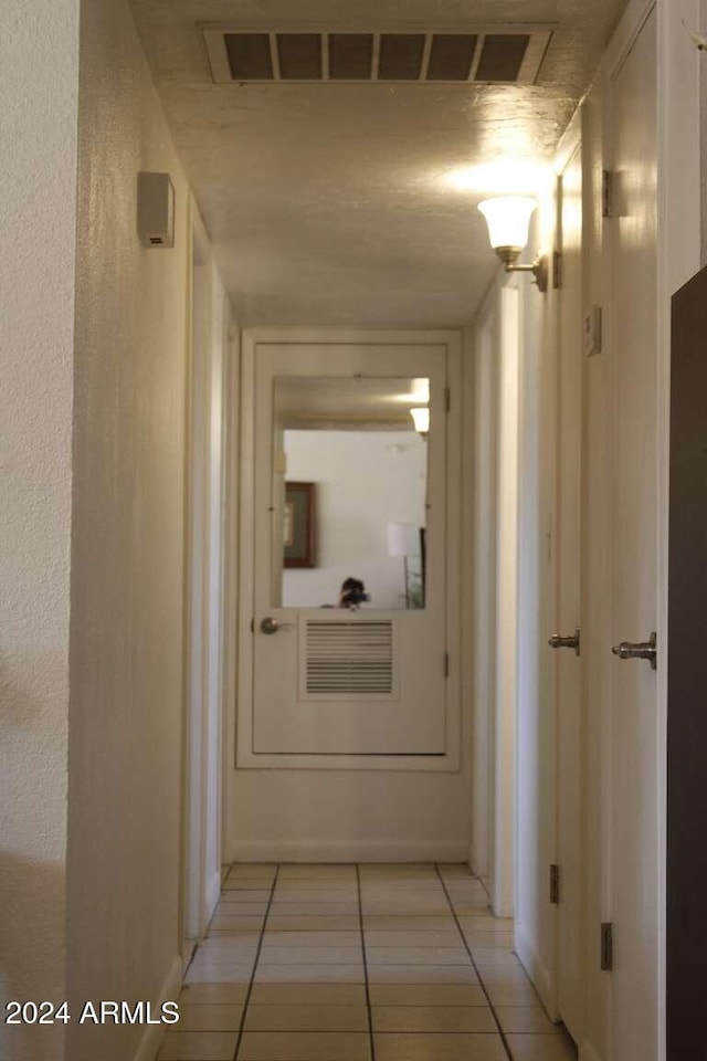 corridor with light tile patterned floors