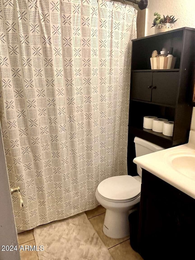 bathroom featuring tile patterned flooring, vanity, and toilet