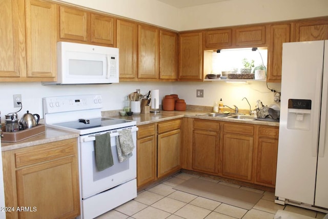 kitchen with sink, light tile patterned floors, and white appliances