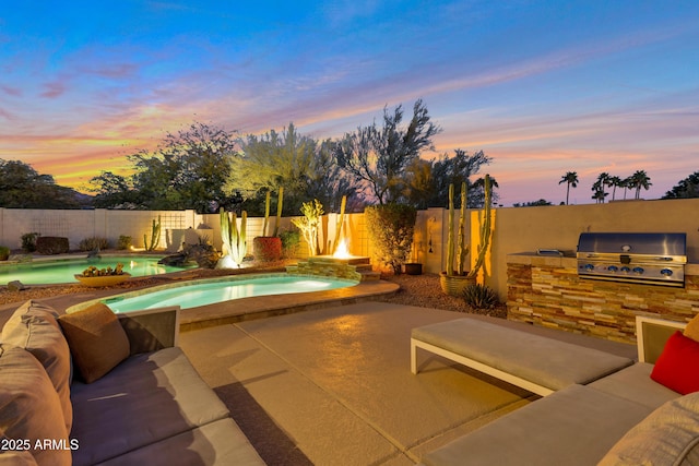 pool at dusk with area for grilling, a patio, grilling area, and a fenced in pool