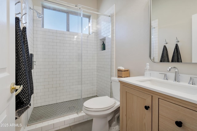 bathroom with toilet, a stall shower, and vanity