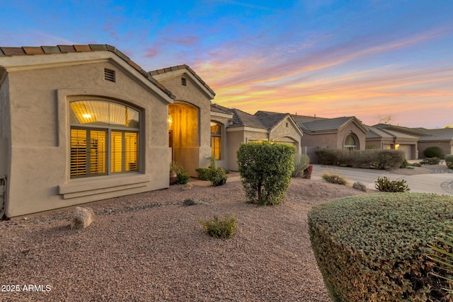 view of front of property with driveway and stucco siding