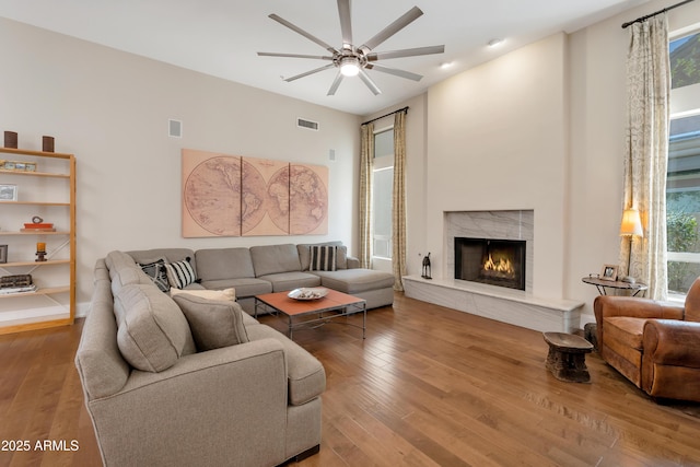 living area with plenty of natural light, visible vents, and wood finished floors