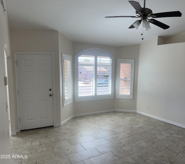 foyer featuring baseboards and a ceiling fan