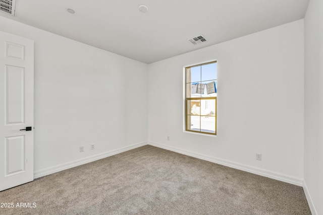 spare room featuring light colored carpet