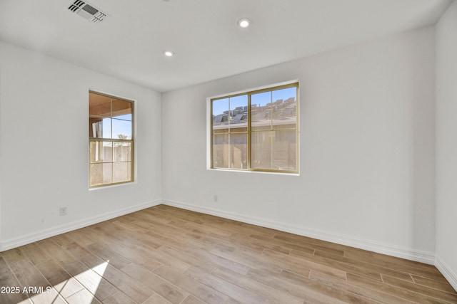 empty room with light hardwood / wood-style flooring