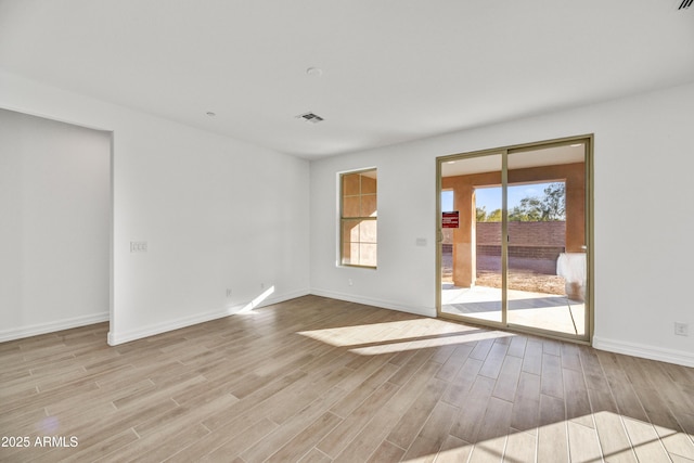 spare room with light hardwood / wood-style floors