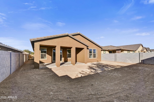 rear view of property featuring a patio area